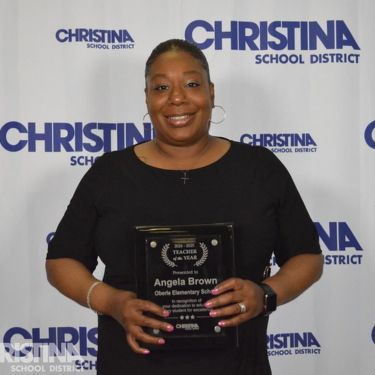 Photo of Angela Brown Teacher of the Year Oberle ES holding award